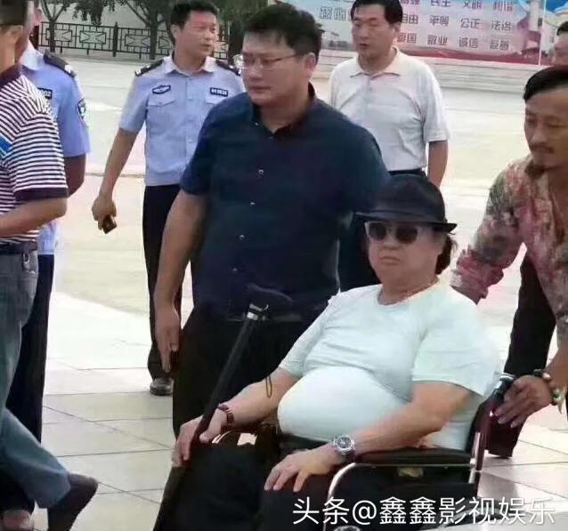 影视巨星洪金宝现身北京，戴大金镶钻链抽雪茄，和朋友相谈甚欢。