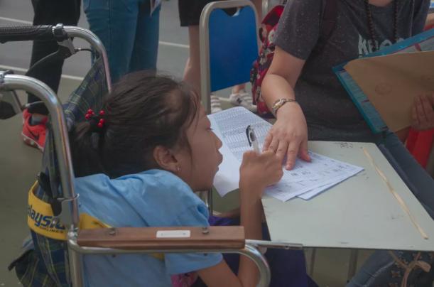 即使因非典而被限制在轮椅上,女孩仍热爱生活,以607分考入川外